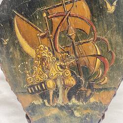 Painted ship on wooden bellows.