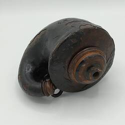 Rounded gun powder flask, wood covered with papier-mache. Wooden stopper & two rings for carriage.