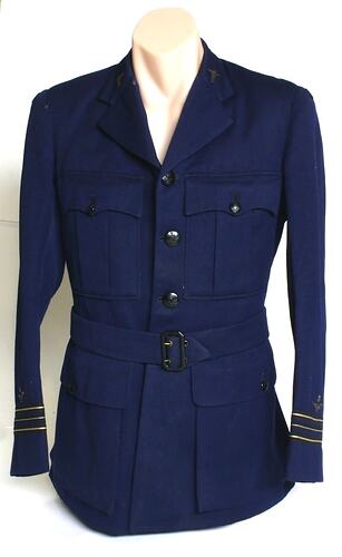 Navy jacket, two breast pockets and two hip pockets. Cloth belt with buckle.