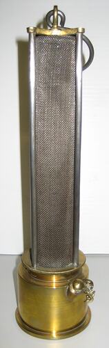 Wire mesh cylindrical lamp with brass top and base.