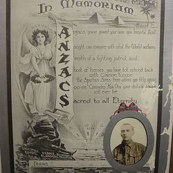 Certificate with image of woman with wings holding a scroll, text and photograph of man in uniform.