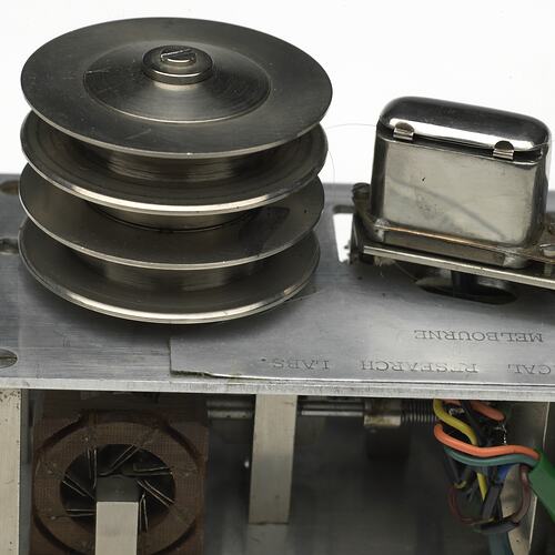 Metal reel with four levels beside switch. Detail.