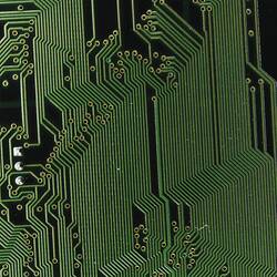 Dark circuit board with multiple green tracking lines.