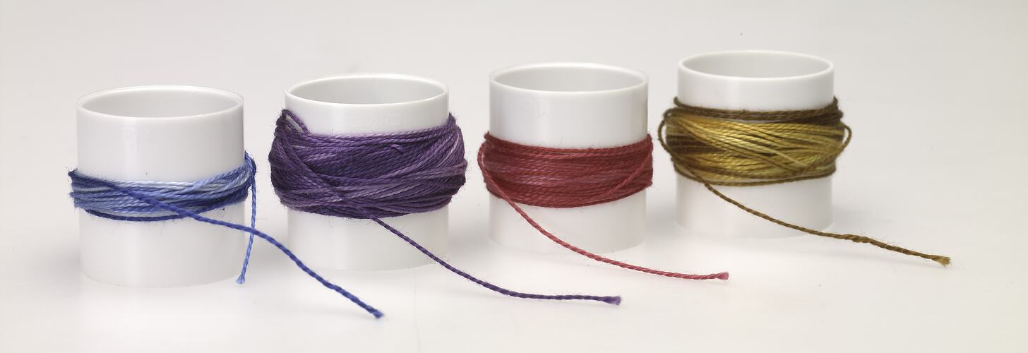 Four spools of coloured thread