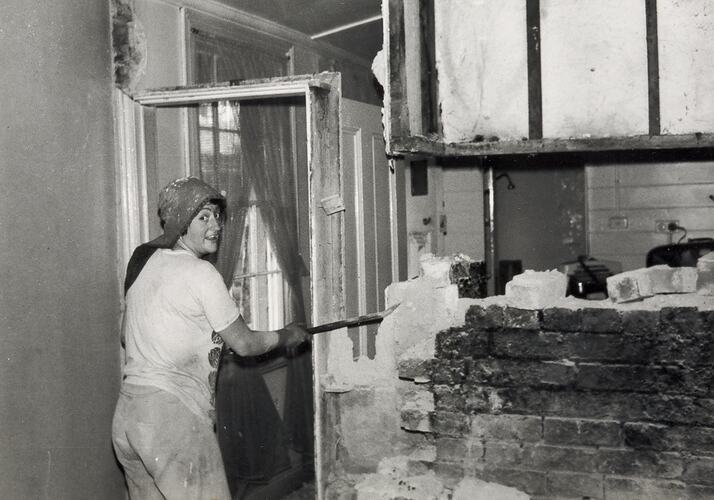 Woman Demolishing Interior Wall in Kitchen, Fitzroy, 1976
