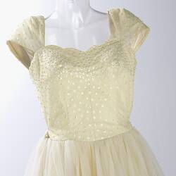 Top half of cream evening dress, yellow sequins.