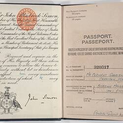 Open passport, white pages, black print. Blue handwritten text.