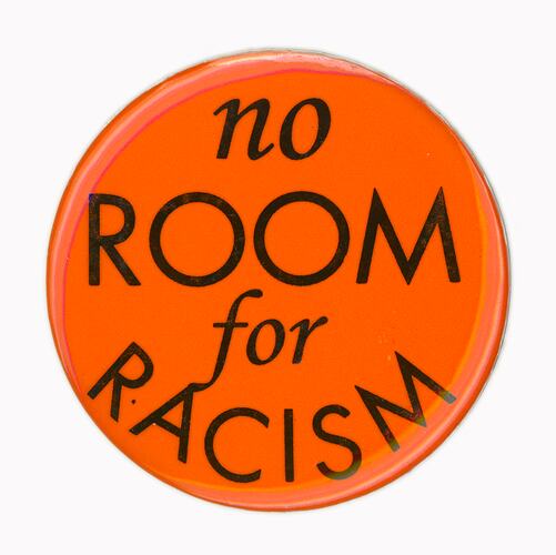 Orange round badge with the inscription "no room for racism"