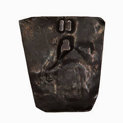 Coin, irregular shape, plain though marked by stamping of obverse.