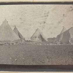 Five tents in field.