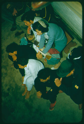 A group of seated athletes wearing uniforms