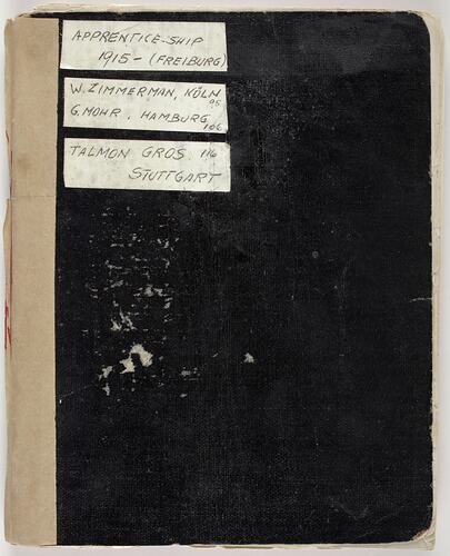 Black covered note book with 3 white handwritten labels top left corner.