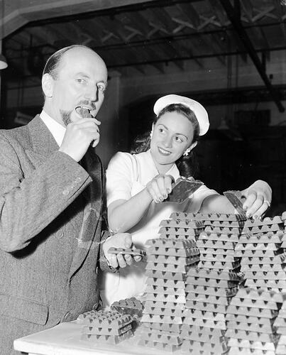 MacRobertson's Pty Ltd, Phillip Law & Woman Eating Chocolate, Victoria, Dec 1953