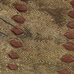 Detail of diamond patterns on wooden shield.