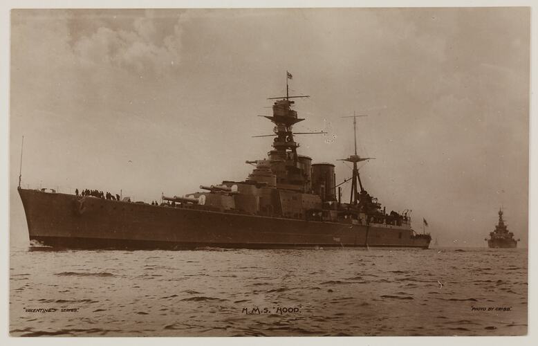 Naval ship at sea, with ship in background on right.