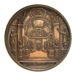 Round medal with internal view of grand hall lined with statues.