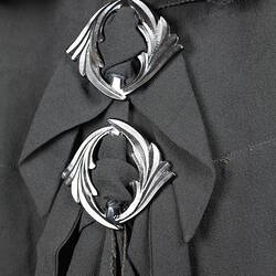 Gathered black fabric with two decorative buckles.