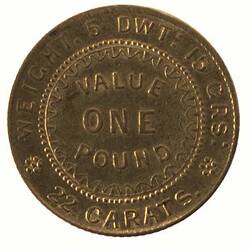 Round coin with raised text.