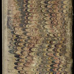 Back cover of worn, discoloured book with marbled patterning.
