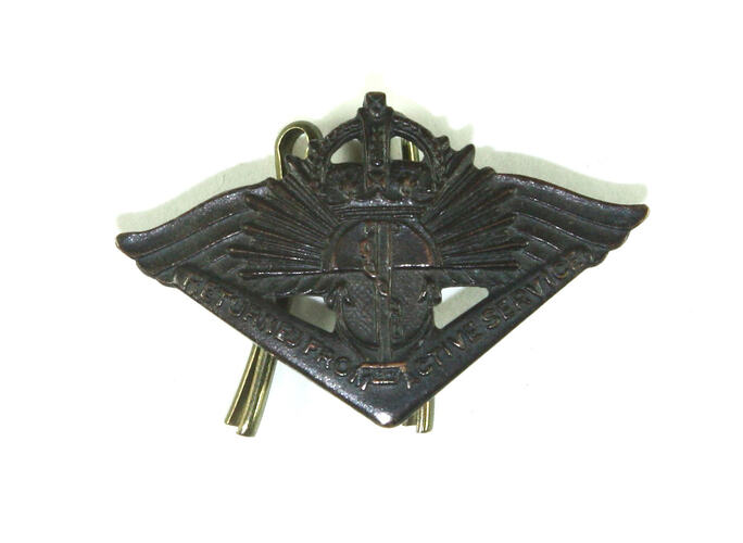Front of triangular cast badge.