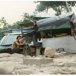 Digital Photograph - Refugees Seated Outside Housing, Refugee Camp, Pulau Bidong, Malaysia, Apr 1981