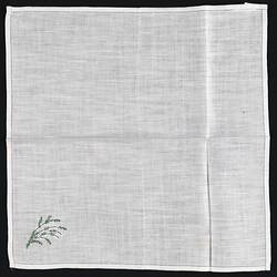 Unfolded handkerchief with embroidered white heather.
