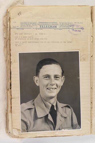 Worn sheet with image of smiling man wearing jacket, tie and shirt. Stamps and typewritten text at top of page