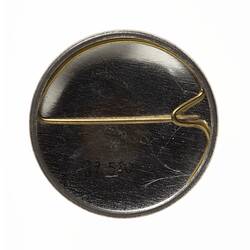 Badge of round metal badge with horizontal pin.