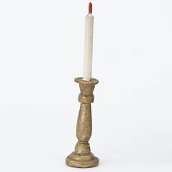 Miniature brass candlestick from a doll's house.