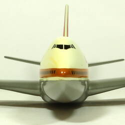 White model plane with red trim and tail. Grey wings. Front view.