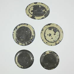 Back of five toy plates.