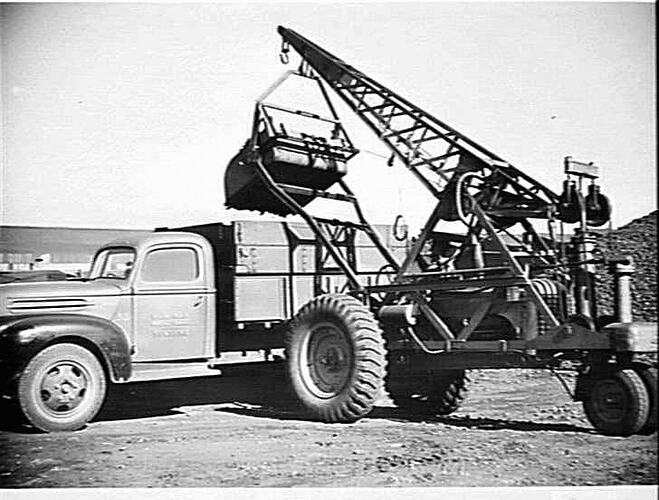 MOBILE CRANE FITTED WITH SCOOP SHOVEL LOADING COKE FROM DUMP TO TRUCK: MAY 1946