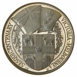 Below the State flag, Arms of Victoria within wreath of Common Pink Heath; text