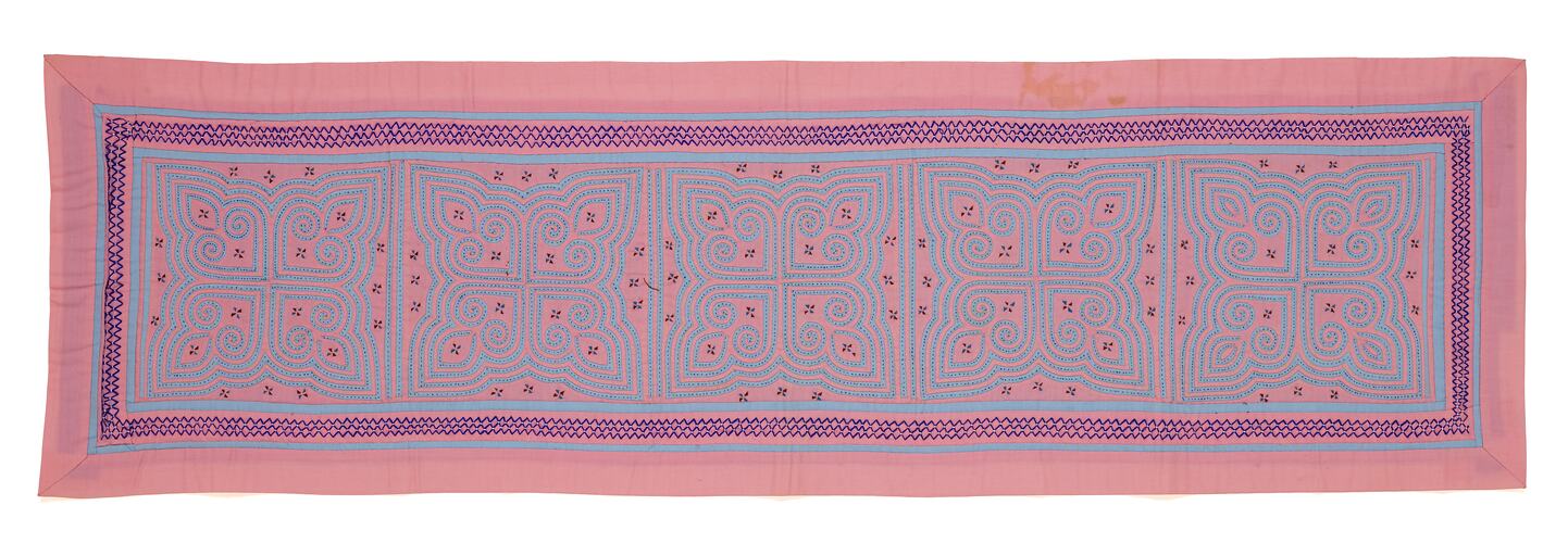 Pink and blue rectangular runner. Five identical maze-like designs along the centre.