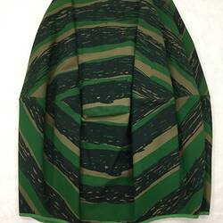 Khaki and black fabric skirt with printed large eye pattern.
