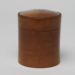 Back of cylindrical wooden box with lid.