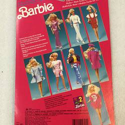 Pink card packaging for Barbie doll. Features 8 Barbie doll images.