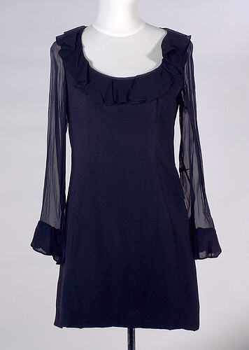 Long sleeved black rayon mini dress, ruffles.