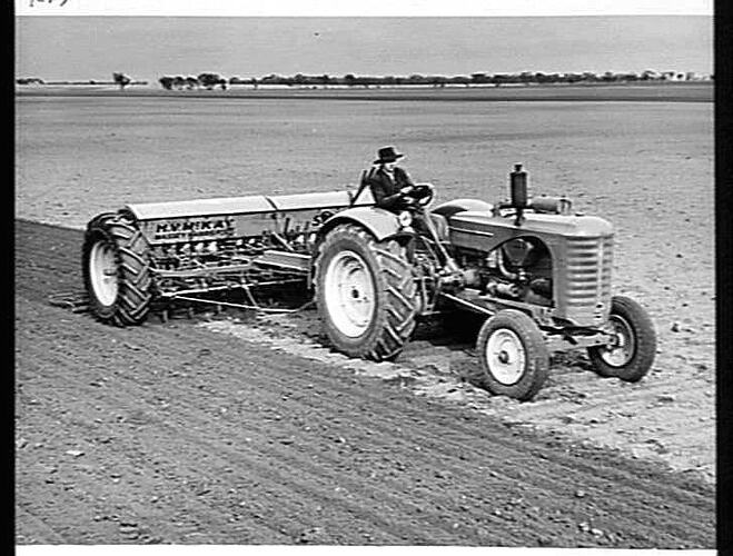 SOWING WHEAT ON THE FARM OF MR. LES HAND, WILLENABRINA, VIA WARRACKNABEAL, VIC. MR. HAND IS USING A `SUNTYNE' EQUIPPED WITH PNEUMATIC TYRES AND TRACTOR HITCH.  THE TRACTOR IS A SUNSHINE MASSEY HARRIS: JUNE 1949