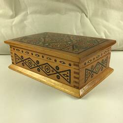 Timber inlay jewellery box. Geometric patterns in dark and light light brown, blue, yellow, white and red.