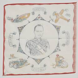 Back of square white cloth handkerchief. Printed portrait of man in decorative frame in black and red.