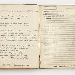 Open book with off white ruled pages. Handwritten and typed text.