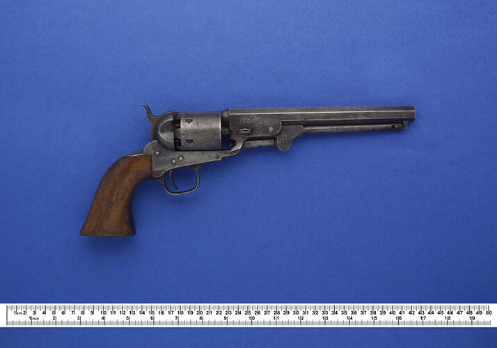 Colt revolver with wooden handle.