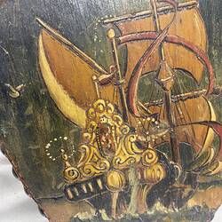 Painted ship on wooden bellows.