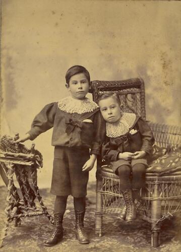 Digital Photograph - Two Boys in Elaborate Lace Collars, One Standing, One Seated in Wicker Chair, Collingwood, circa 1895