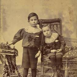 Digital Photograph - Two Boys in Elaborate Lace Collars, One Standing, One Seated in Wicker Chair, Collingwood, circa 1895
