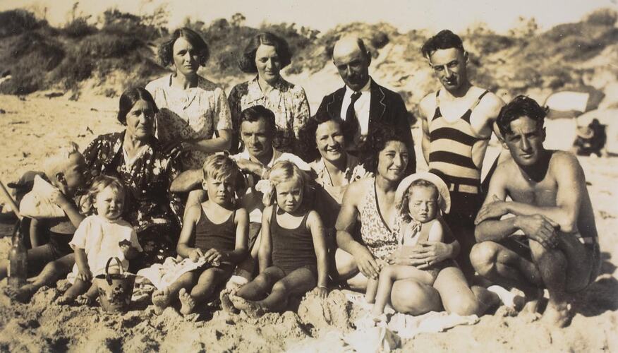 Group of people posing at a beach.