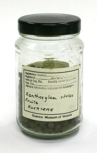 Dried fruit sample in glass jar with a black lid.