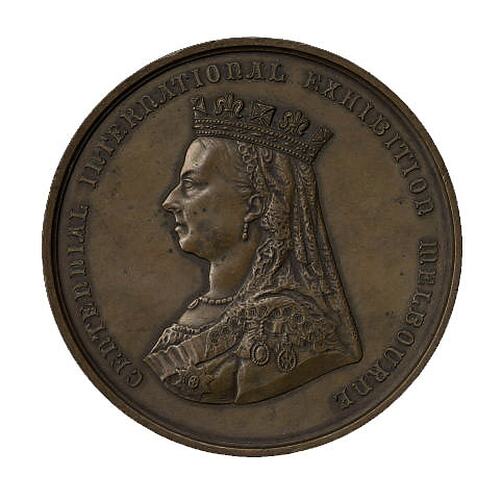Brown round medal with portrait of Queen Victoria facing left.