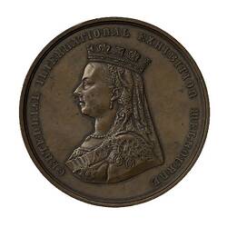 Brown round medal with portrait of Queen Victoria facing left.